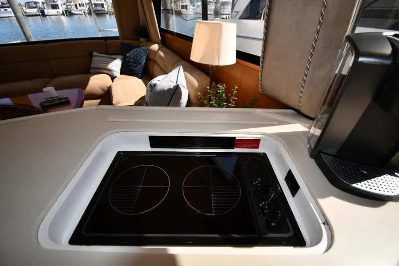 Slide: The Image of Interior of 1996 Viking 53 Convertible yacht with modern kitchen and cozy seating area. - 75