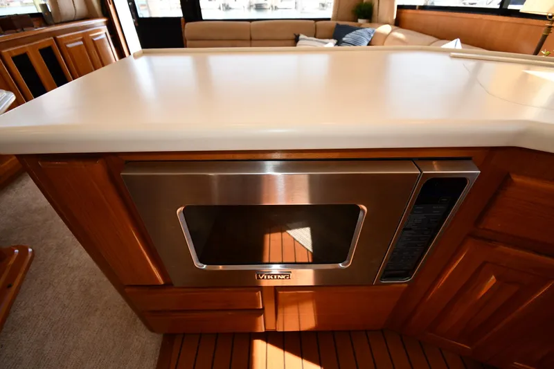 Slide: The Image of Modern kitchen area in a 1996 Viking 53 Convertible yacht with built-in microwave. - 76