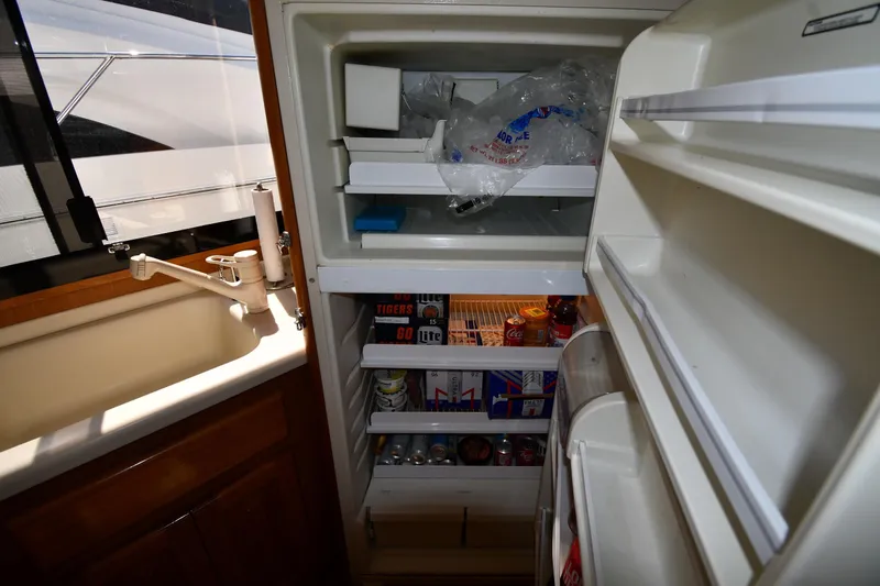 Slide: The Image of Refrigerator inside 1996 Viking 53 Convertible yacht, stocked with beverages and ice. - 77