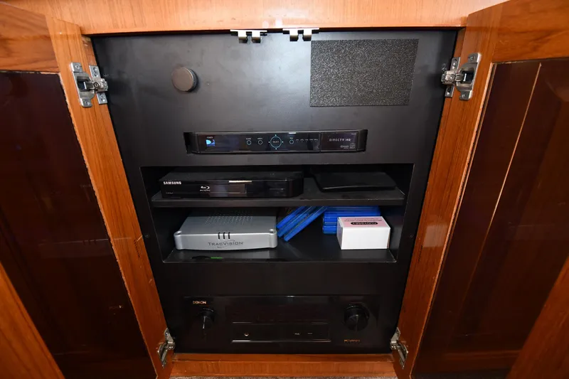 Slide: The Image of Entertainment system cabinet on a 1996 Viking 53 Convertible yacht, featuring various electronic devices. - 79
