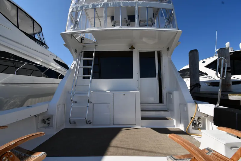 Slide: The Image of 1996 Viking 53 Convertible yacht stern view with ladder and deck area. - 8