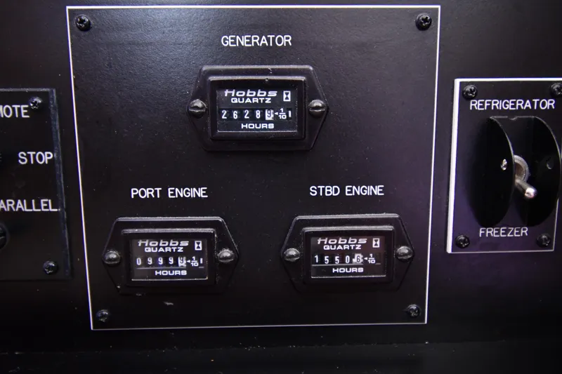 Slide: The Image of Control panel of a 1996 Viking 53 Convertible boat with engine hour meters. - 81