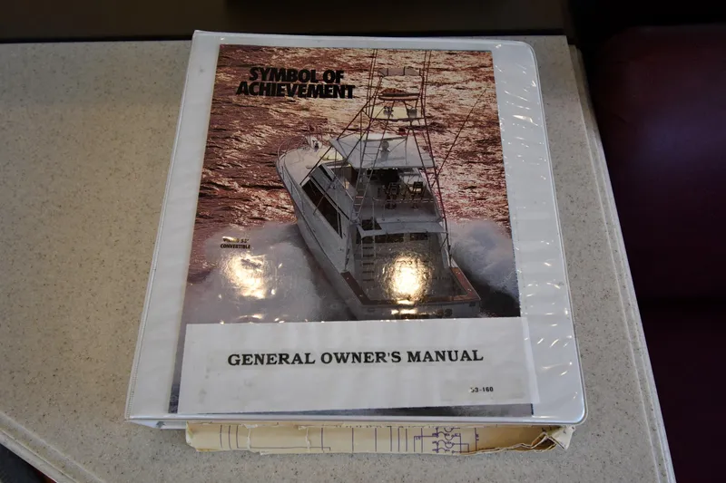 Slide: The Image of Owner's manual for 1996 Viking 53 Convertible yacht on a table. - 82