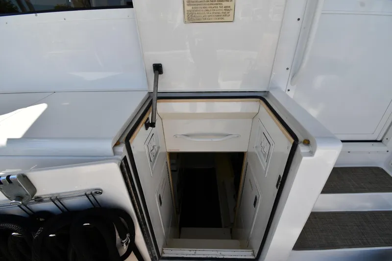 Slide: The Image of Hatch entrance on a 1996 Viking 53 Convertible yacht, showing steps and storage compartments. - 83