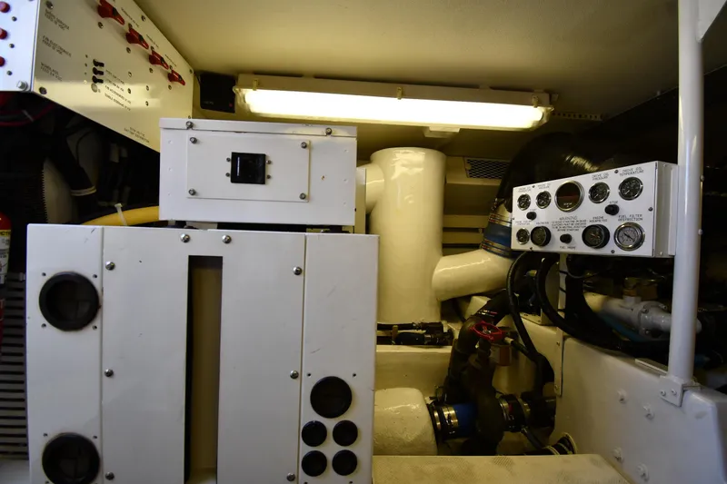 Slide: The Image of Engine room of a 1996 Viking 53 Convertible yacht, featuring control panels and machinery. - 86