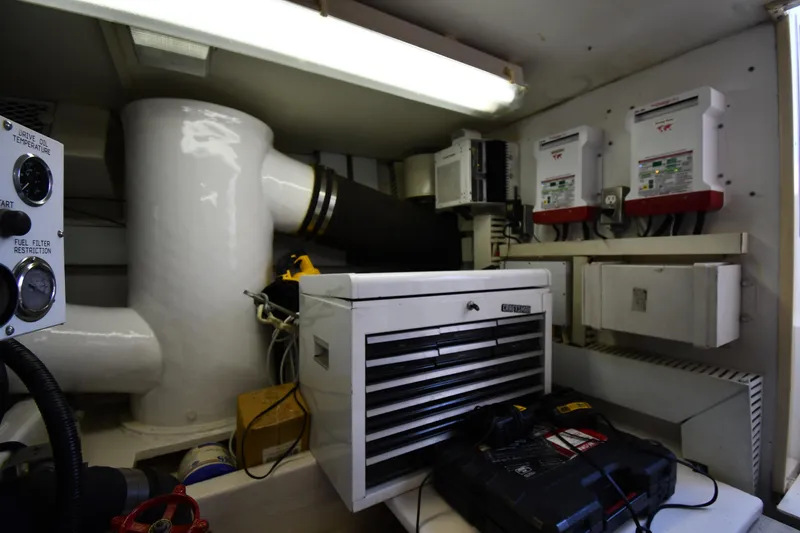 Slide: The Image of Engine room of a 1996 Viking 53 Convertible yacht with control panels and equipment. - 88