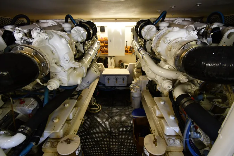 Slide: The Image of Engine room of a 1996 Viking 53 Convertible yacht, showcasing dual engines and mechanical components. - 89