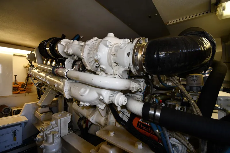 Slide: The Image of Engine room of a 1996 Viking 53 Convertible yacht, showcasing detailed machinery components. - 90
