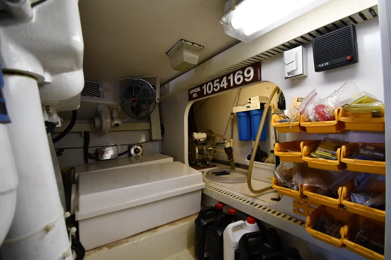 Slide: The Image of Engine room of a 1996 Viking 53 Convertible yacht with organized storage and equipment. - 93
