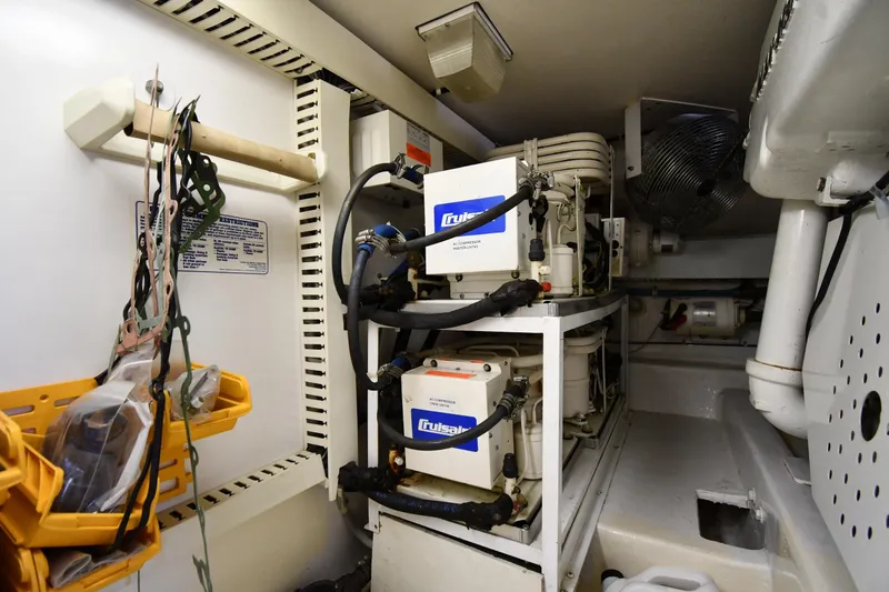 Slide: The Image of Engine room of 1996 Viking 53 Convertible yacht with mechanical equipment and storage. - 94