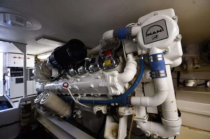 Slide: The Image of Engine room of a 1996 Viking 53 Convertible yacht featuring a MAN engine. - 96
