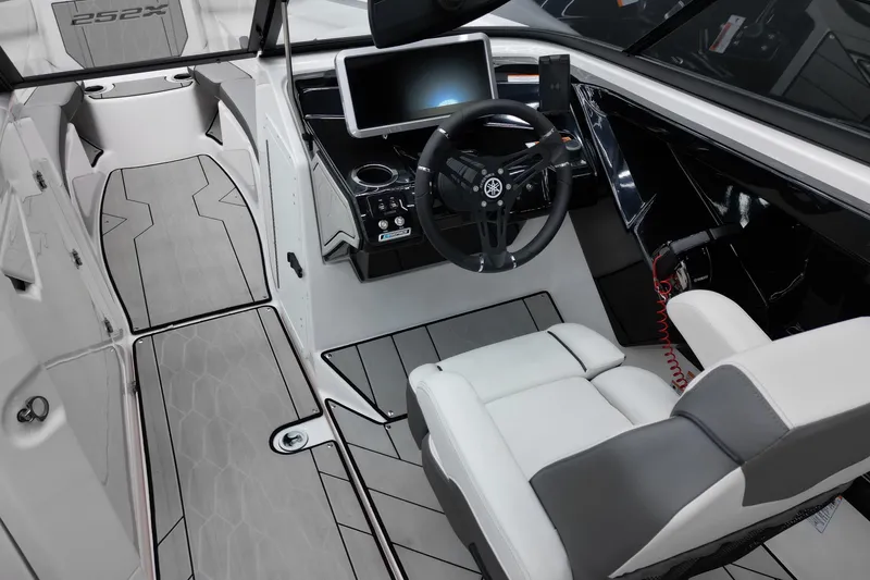 Slide: The Image of 2024 Yamaha Boats 252XE cockpit with modern steering, touchscreen, and sleek seating design. - 14