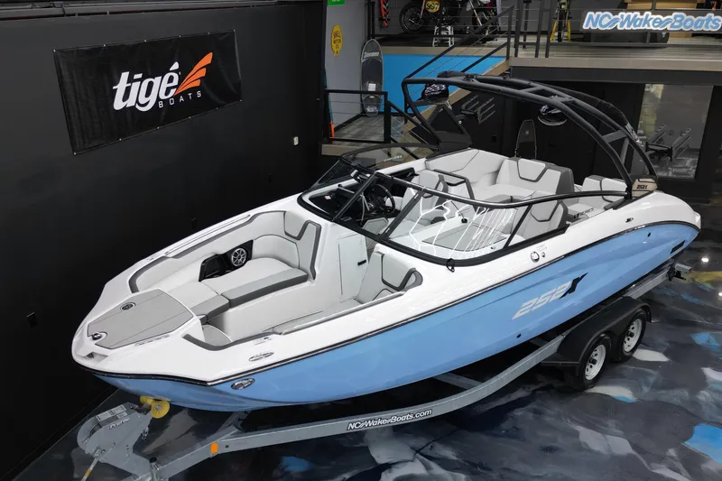 Slide: The Image of 2024 Yamaha Boats 252XE in showroom, sleek design, blue and white color scheme. - 5