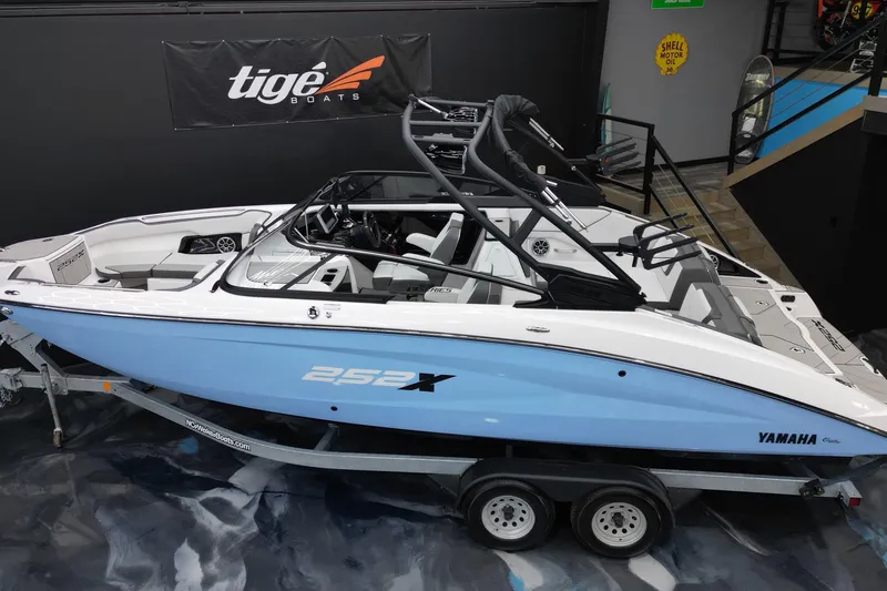 Slide: The Image of 2024 Yamaha Boats 252XE in showroom, sleek design, blue and white color scheme. - 7