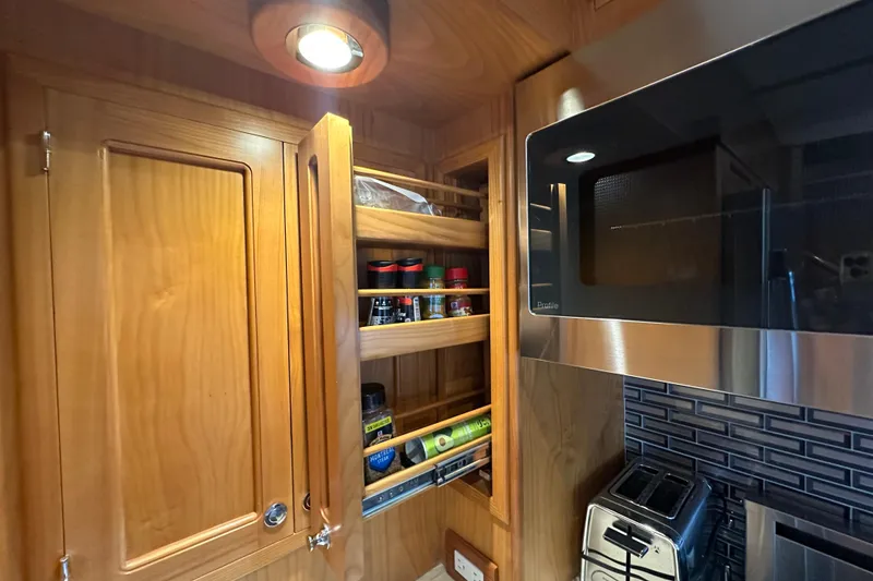 Slide: The Image of Wooden kitchen cabinet with pull-out spice rack in Kadey-Krogen 44AE yacht, 2021 model. - 10