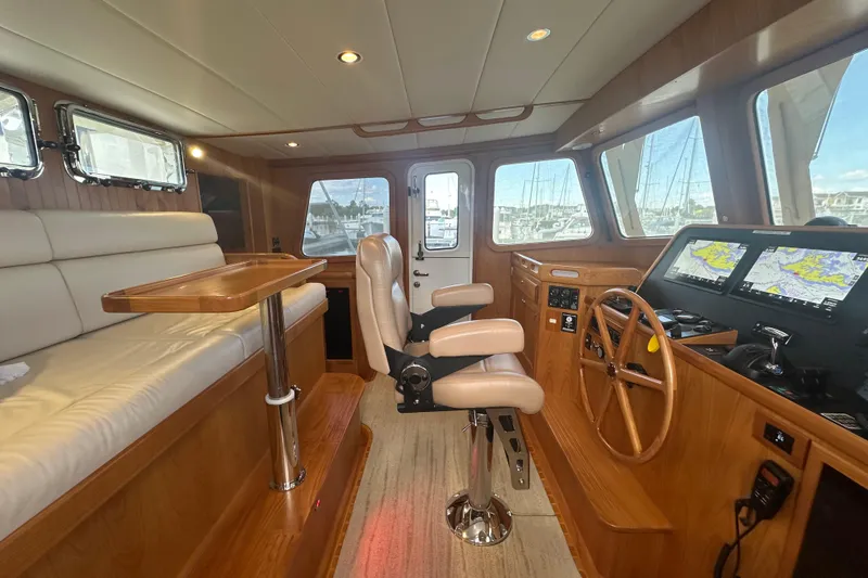 Slide: The Image of Luxurious 2021 Kadey-Krogen 44AE yacht interior with navigation equipment and plush seating. - 13