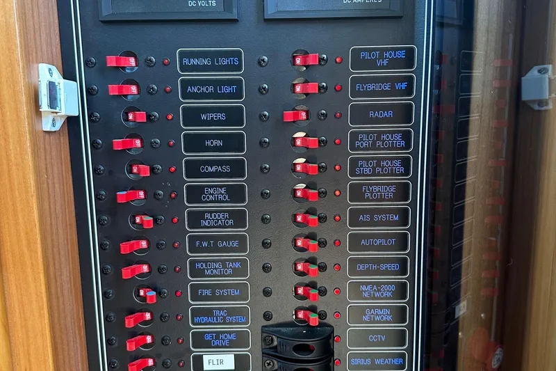 Slide: The Image of Electrical control panel on a 2021 Kadey-Krogen 44AE yacht with labeled switches. - 17