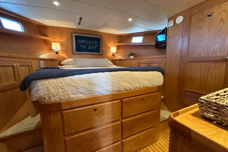 Slide: The Image of Luxurious 2021 Kadey-Krogen 44AE yacht cabin with cozy bed and wooden interior. - 19