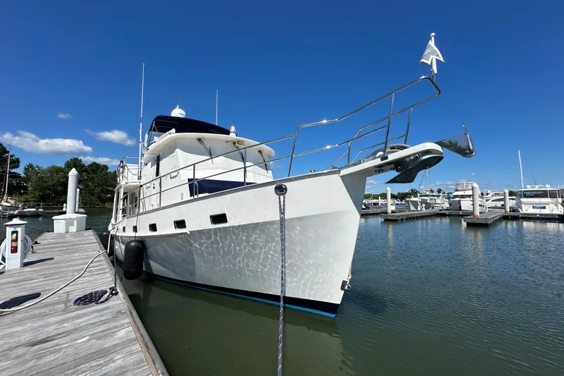 Slide: The Image of 2021 Kadey-Krogen 44AE yacht docked at marina under clear blue sky. - 2