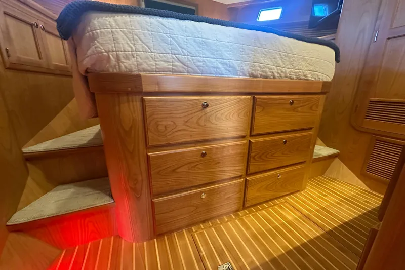 Slide: The Image of Luxurious wooden interior of 2021 Kadey-Krogen 44AE yacht with built-in storage drawers. - 20