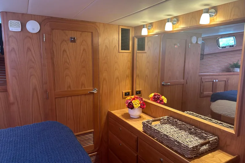 Slide: The Image of Luxurious 2021 Kadey-Krogen 44AE yacht interior with wood paneling and elegant decor. - 21