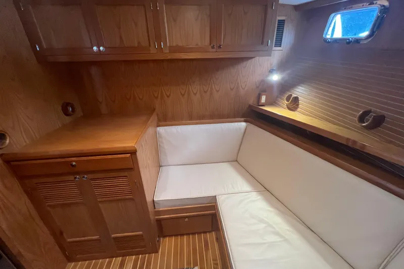 Slide: The Image of Luxurious 2021 Kadey-Krogen 44AE yacht interior with wood paneling and white seating. - 24