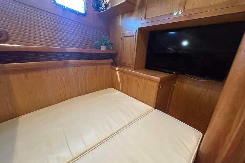 Slide: The Image of Cozy cabin interior of 2021 Kadey-Krogen 44AE with TV and wooden furnishings. - 28