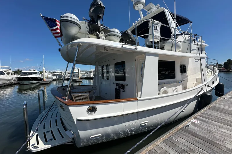 Slide: The Image of 2021 Kadey-Krogen 44AE yacht docked at marina under clear blue sky. - 3