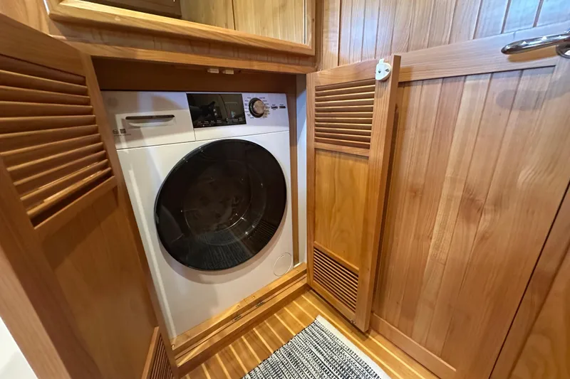 Slide: The Image of Laundry area with a modern washer inside a Kadey-Krogen 44AE yacht, 2021 model. - 30