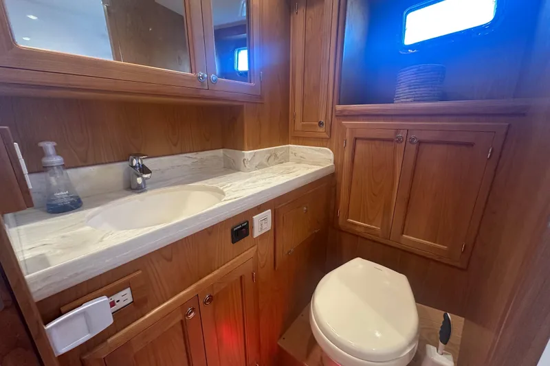 Slide: The Image of Luxurious 2021 Kadey-Krogen 44AE yacht bathroom with wooden cabinetry and modern fixtures. - 31