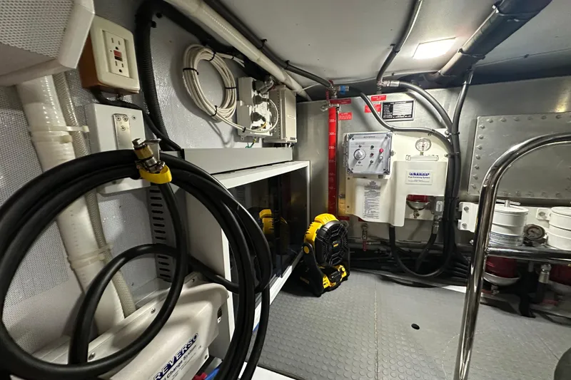Slide: The Image of Engine room of 2021 Kadey-Krogen 44AE yacht, featuring equipment and wiring. - 34