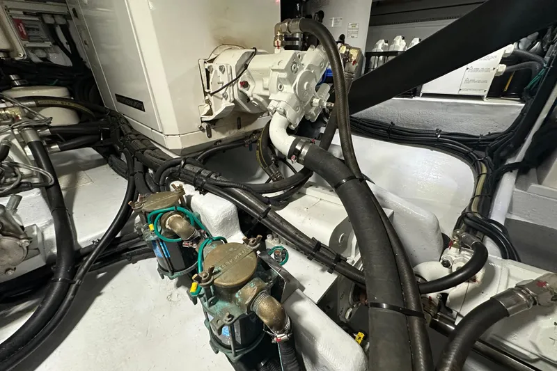 Slide: The Image of Engine room of 2021 Kadey-Krogen 44AE yacht, showcasing complex machinery and cables. - 39