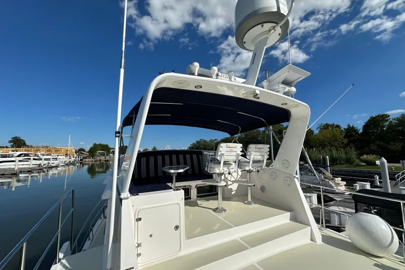 Slide: The Image of 2021 Kadey-Krogen 44AE yacht with seating area, docked under clear blue sky. - 41