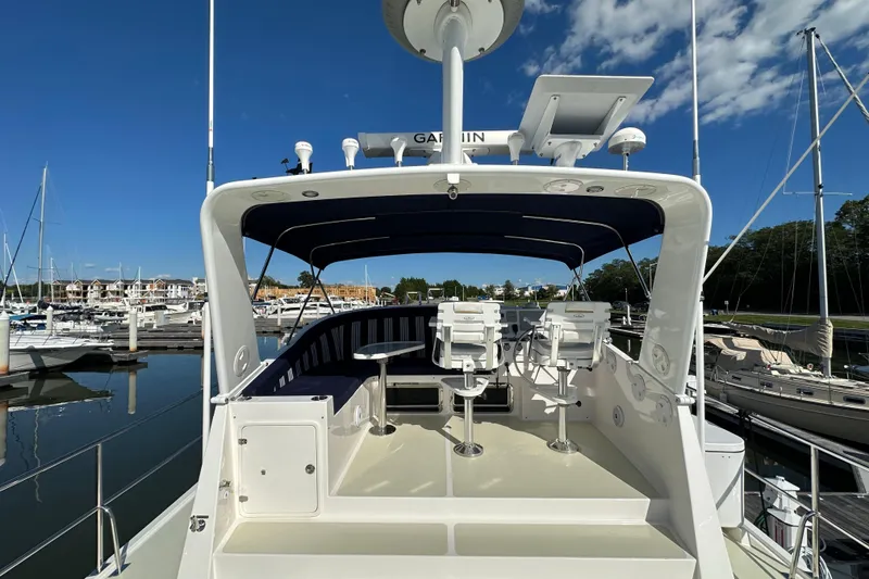 Slide: The Image of Flybridge of 2021 Kadey-Krogen 44AE yacht docked at marina under clear blue sky. - 42