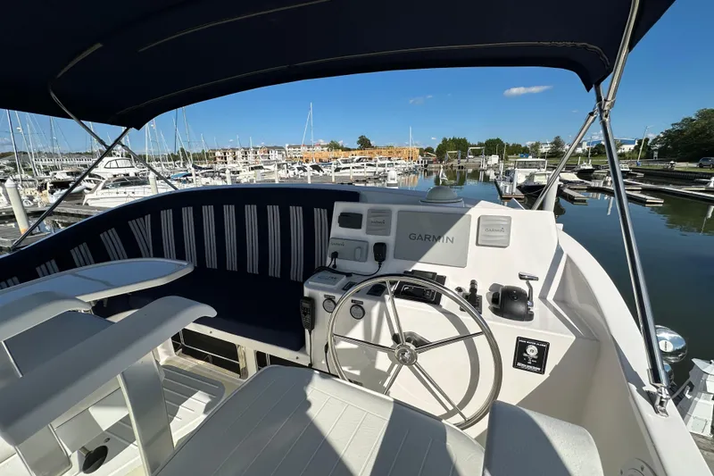 Slide: The Image of Helm of 2021 Kadey-Krogen 44AE yacht with Garmin navigation, docked at marina. - 44