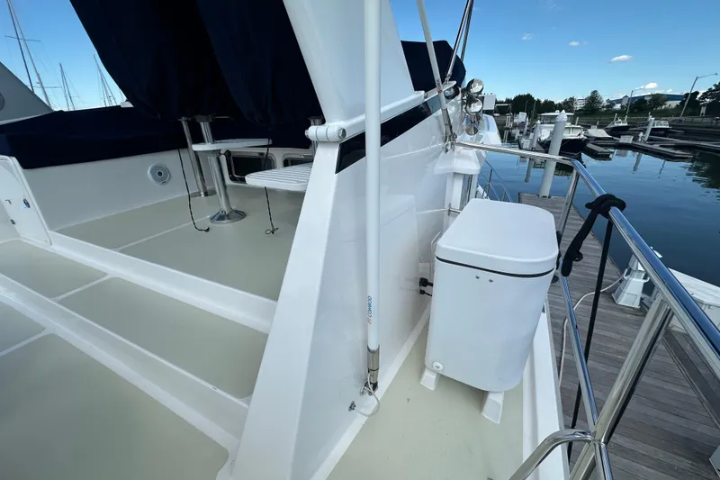 Slide: The Image of 2021 Kadey-Krogen 44AE yacht deck with seating and marina view. - 47