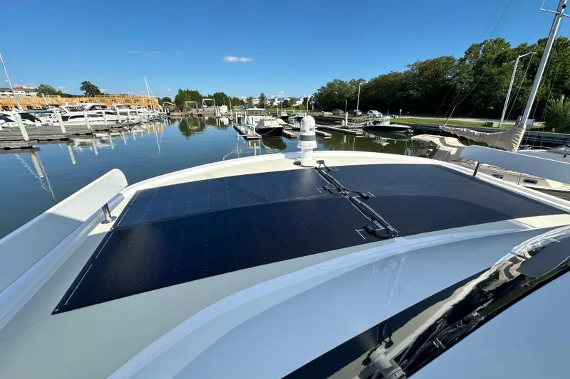 Slide: The Image of 2021 Kadey-Krogen 44AE yacht with solar panels docked at a marina. - 50