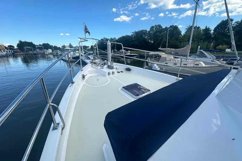 Slide: The Image of Kadey-Krogen 44AE 2021 yacht docked in a serene marina under a clear blue sky. - 52