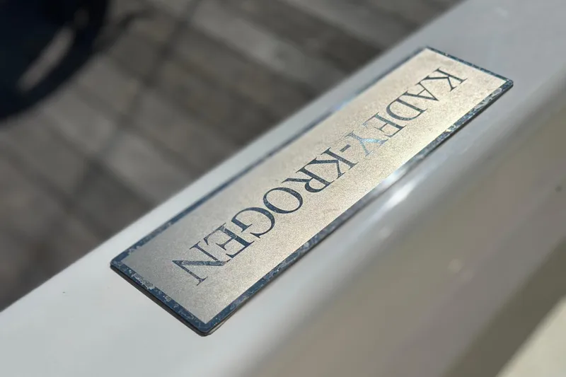 Slide: The Image of Kadey-Krogen 44AE 2021 nameplate on a boat railing, close-up view. - 58