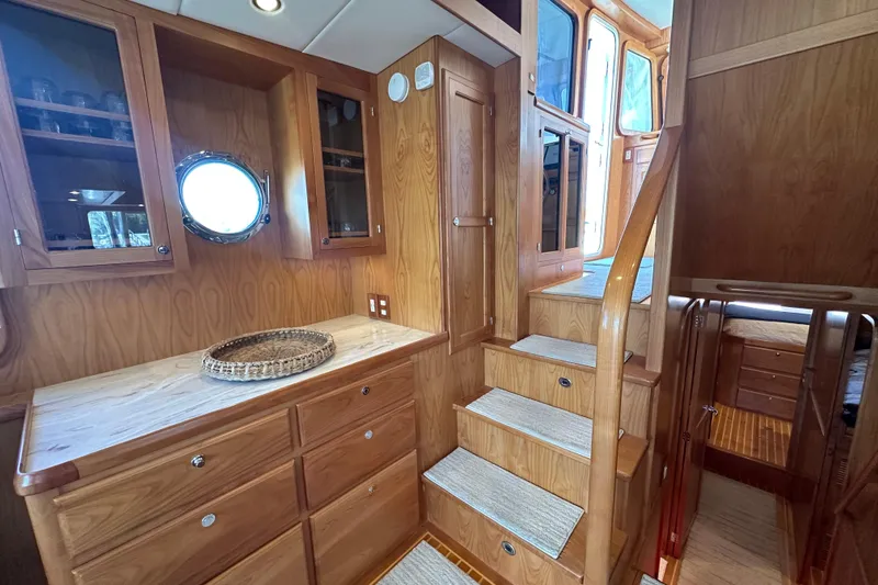 Slide: The Image of Luxurious wooden interior of 2021 Kadey-Krogen 44AE yacht with stairs and cabinetry. - 7
