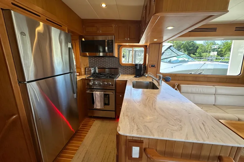Slide: The Image of Luxurious 2021 Kadey-Krogen 44AE yacht kitchen with modern appliances and elegant wood finish. - 9