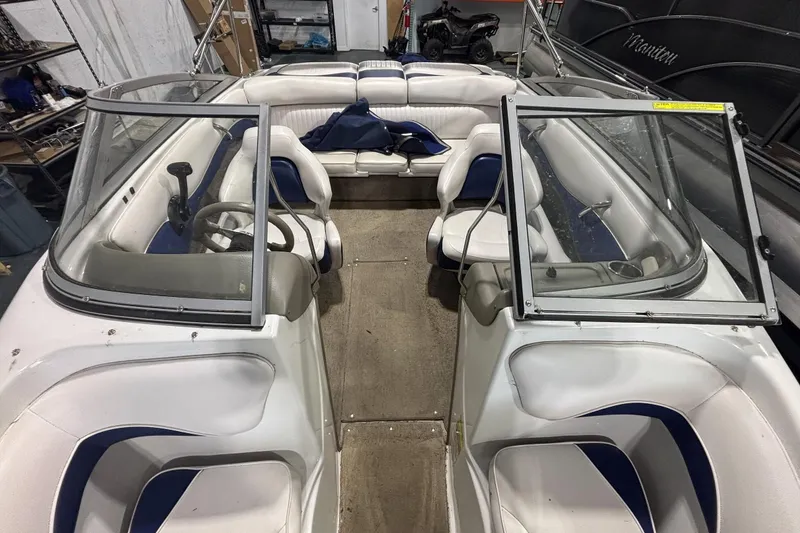 Slide: The Image of 2013 Crownline 185 SS boat interior with white and blue seating, open windshield. - 11