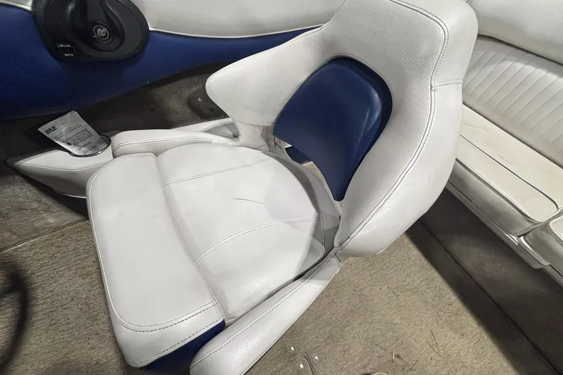 Slide: The Image of White and blue seat in a 2013 Crownline 185 SS boat interior. - 12