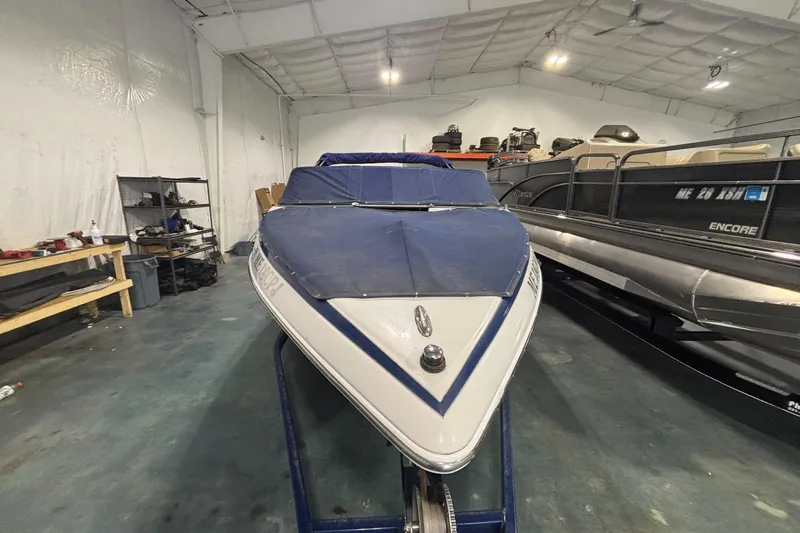 Slide: The Image of 2013 Crownline 185 SS boat in storage, covered and secured indoors. - 3