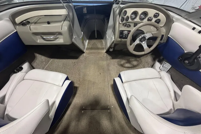 Slide: The Image of Interior of a 2013 Crownline 185 SS boat with white and blue seating. - 8
