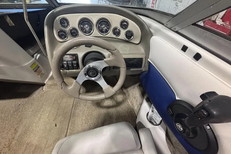 Slide: The Image of 2013 Crownline 185 SS boat dashboard with steering wheel and instrument panel. - 9