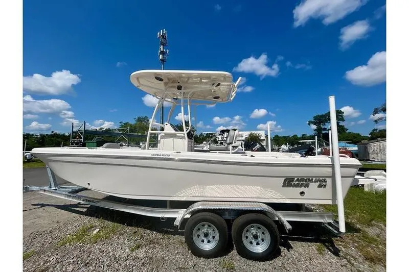 The Image of 2026 Carolina Skiff 21 Ultra Elite boat on trailer under clear blue sky. - 1