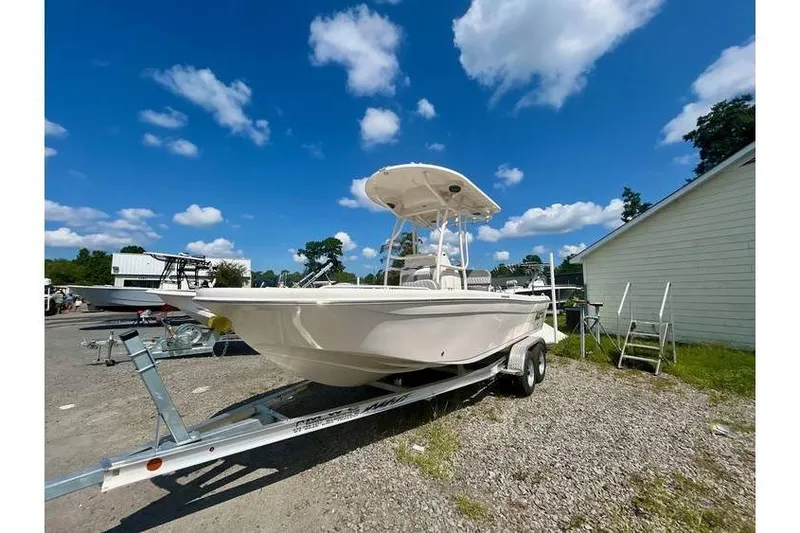 Slide: The Image of 2026 Carolina Skiff 21 Ultra Elite boat on trailer under blue sky. - 7