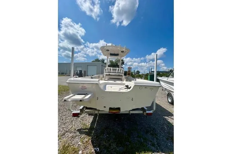 Slide: The Image of 2026 Carolina Skiff 21 Ultra Elite boat, rear view under a bright blue sky. - 9