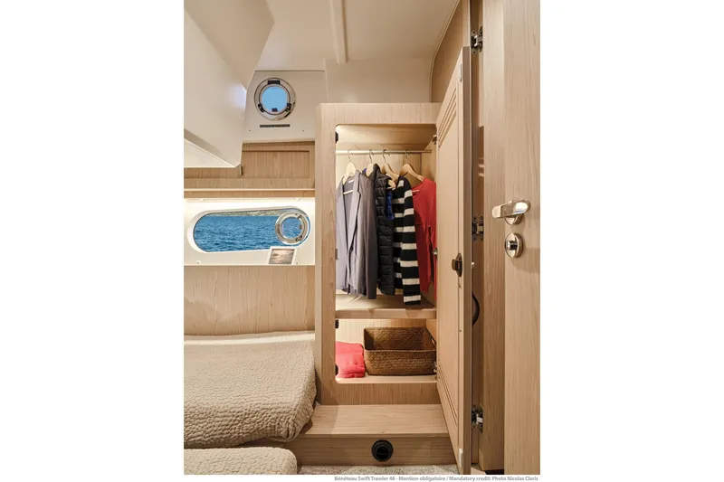 Slide: The Image of Interior of 2026 Beneteau Swift Trawler 48 with cozy cabin and wardrobe. - 12